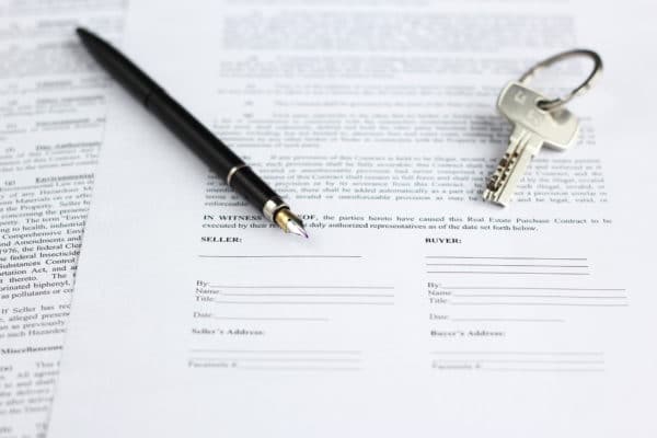 Legal document for sale of real estate, with a gold-nibbed fountain pen and house keys - Deed in Lieu of Foreclosure Lawyer in Florida Foreclosure Defense Group